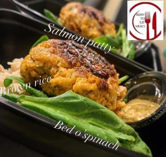 Salmon patty with rice and raw spinach